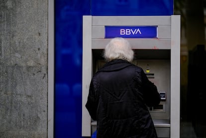 Una mujer saca dinero de un cajero del BBVA en Barcelona.