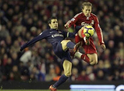 Cesc Fábregas lucha por un balón con el jugador del Liverpool Lucas.