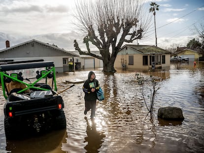 Brenda Ortega, 15, salvages items from her flooded Merced, Calif., home on Tuesday, Jan. 10, 2023.