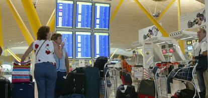 Viajeros esperando para facturar sus maletas en la terminal de Barajas.