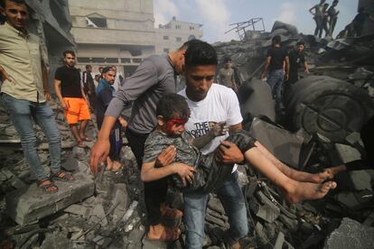 Un hombre traslada a un niño herido tras un bombardeo israelí sobre la ciudad de Rafah. 