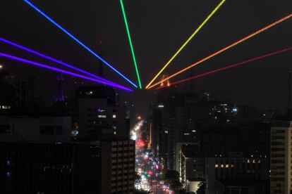 The Global Rainbow, a large scale outdoor laser projection created by Puerto Rican artist Yvette Mattern, is projected into the night sky to mark Gay Pride Parade Day, which was cancelled due to the COVID-19 novel coronavirus pandemic, in Sao Paulo, Brazil, on June 14, 2020. (Photo by Nelson ALMEIDA / AFP)