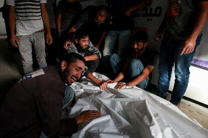 Varios palestinos lloran junto a los cadáveres de sus familiares muertos en un ataque israelí sobre un campo de desplazados en Rafah, este lunes. 