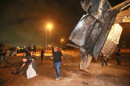 Israeli authorities inspect the remains of what the military said is a Syrian anti-aircraft rocket that exploded in the air, in the town of Rahat, Israel, Sunday, July 2, 2023.