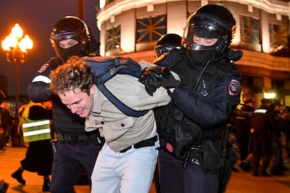 Police officers detain an anti-war protester in Moscow on Wednesday.