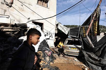 Several people inspect the damage caused by an Israeli raid on the Nur Shams refugee camp in the West Bank on Sunday.