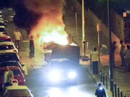 Un contenedor ardiendo tras los disturbios provocados por cientos de j&oacute;venes durante el concierto.