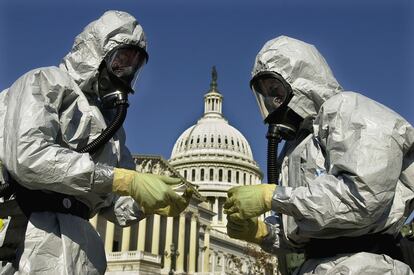 With the U.S. Capitol in the background, members of an U.S. Marine Corps' Chemical-Biological Incident Response Force demonstrate anthrax clean-up techniques during a news conference in Washington in this Oct. 30, 2001 file photo