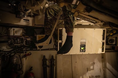 The 26th Brigade's gunners enter the armored vehicle without boots and work barefoot to avoid filling the interior with mud.