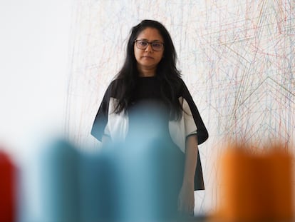 Retrato de la artista Shilpa Gupta, ante su obra 'Stars on Maps of the World'.