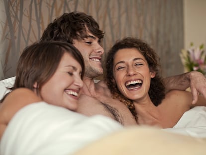 Three people in bed together.