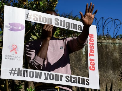 A person holds an advocacy placard at the Ice Breakers Uganda (IBU) clinic in Makindye that supports HIV/AIDS programs and treatment in Salaama road, Kampala, Uganda, on June 1, 2023.