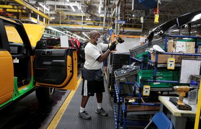 A Ford Motor assembly worker works on a 2021 Bronco SUV  at Michigan Assembly Plant in Wayne, Michigan, U.S., June 14, 2021.