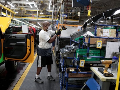 A Ford Motor assembly worker works on a 2021 Bronco SUV  at Michigan Assembly Plant in Wayne, Michigan, U.S., June 14, 2021.