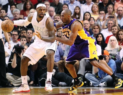 James protege el balón ante Kobe.