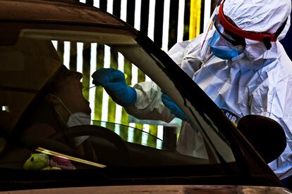 A health worker performs a swab test for coronavirus in Pozzuoli near Naples.