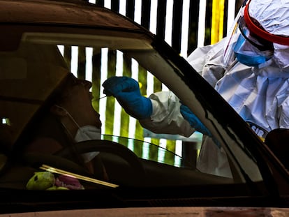 A health worker performs a swab test for coronavirus in Pozzuoli near Naples.