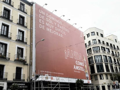 Una lona publicitaria tapa la fachada de un edificio en la Plaza del Cascorro, en La Latina