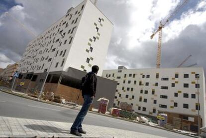 Un joven observa la construcción de viviendas de promoción pública en el Ensanche Sur de Alcorcón (Madrid).