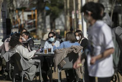 Cuatro personas en la terraza de un bar. 