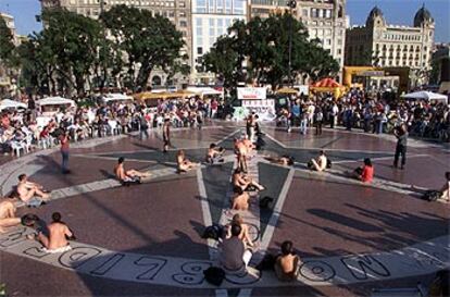 Una veintena de participantes formando el signo de la paz desnudos, ayer, en la plaza de Catalunya de Barcelona.