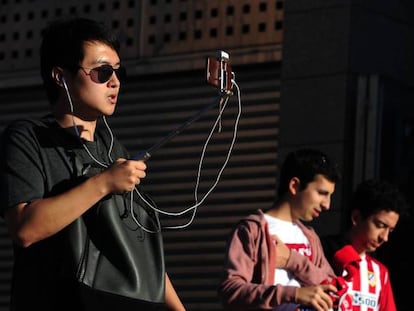 An Atlético Madrid fan livestreams on his mobile phone before a match.