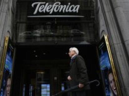 Una persona pasea ante la tienda de Telef&oacute;nica en Gran V&iacute;a, en Madrid.