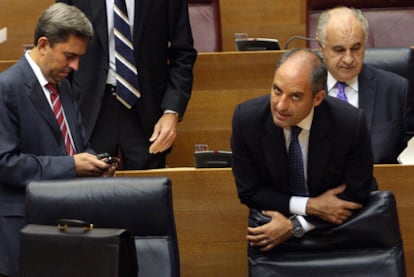 El presidente de la Generalitat, Francisco Camps, entre el vicepresidente Vicente Rambla y el consejero Rafael Blasco, ayer en un receso del debate de política general.