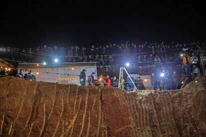 Bystanders watch as Moroccan authorities and firefighters work to rescue five-year-old Rayan.