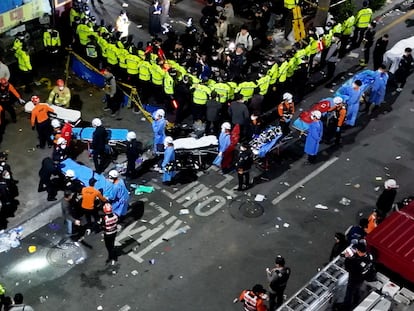 Rescue workers work at the scene where a stampede during Halloween festivities killed an injured many people at the popular Itaewon district in Seoul, South Korea, October 30, 2022. Yonhap via REUTERS ATTENTION EDITORS - THIS IMAGE HAS BEEN SUPPLIED BY A THIRD PARTY. SOUTH KOREA OUT. NO RESALES. NO ARCHIVES.