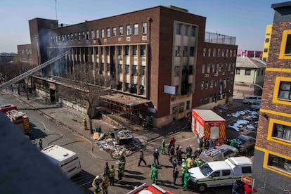 Bomberos y personal de emergencia trabajan en la extinción del incendio en el centro de Johannesburgo (Sudáfrica), este jueves.  