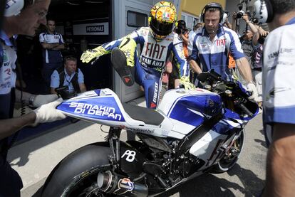 Rossi ha necesitado un poco de  ayuda para subirse a su moto