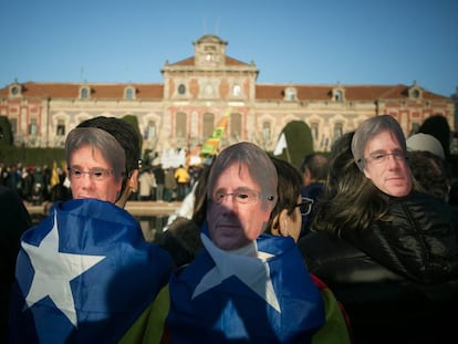 Wearing Puigdemont masks, separatists protested outside Catalan Parliament yesterday.