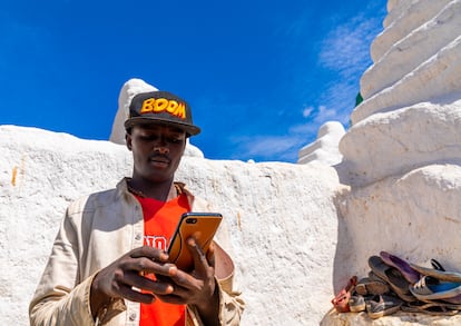 Un peregrino ormo utiliza un teléfono móvil en el santuario Sheikh Hussein, en la región etíope de Oromia.