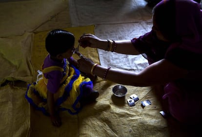 Una trabajadora sanitaria administra una pastilla a una niña en Neemrana, a 123 kilómetros de Nueva Delhi. El Gobierno indio está desarrollando una campaña nacional de para prevenir los parásitos para mejorar el desarrollo físico y mental de los niños. El tratamiento pretende llegar a 270 millones de menores.