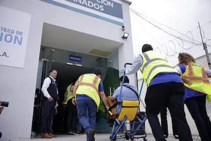 Un exprisionero es ayudado por trabajadores del aeropuerto La Aurora en Ciudad de Guatemala para llegar a la terminal.