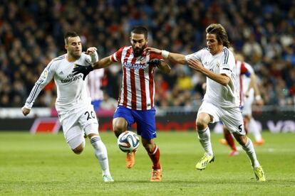 Arda Turan persigue el balón ante Jesé y Coentrao