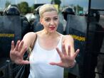 Maria Kolesnikova, one of Belarus' opposition leaders, center, gestures during a rally in Minsk, Belarus, Sunday, Aug. 30, 2020. Tens of thousands of demonstrators have gathered in the capital of Belarus, beginning the fourth week of daily protests demanding that the country's authoritarian president resign. The protests began after an Aug. 9 presidential election that protesters say was rigged and officials say gave President Alexander Lukashenko a sixth term in office. (Tut.By via AP)