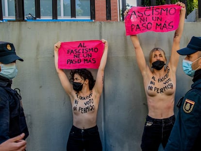 EDS NOTE: NUDITY - Members of feminist group FEMEN protest with their bare chest reading "No vote neither permission to fascism" raise a banner reading "Not another step to fascism"in front of the poll station where the far right party Vox candidate Rocio Monasterio will vote during the regional election for a new regional assembly in Madrid, Spain, Tuesday, May 4, 2021. Over 5 million Madrid residents are voting Tuesday for a new regional assembly in an election that tests the depths of resistance to lockdown measures and the divide between left and right-wing parties. (AP Photo/Manu Fernandez)