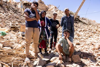 Members of the Mhamd family standing on what used to be their house. Pictured are Fadela, her brother-in-law Said and her surviving children. 