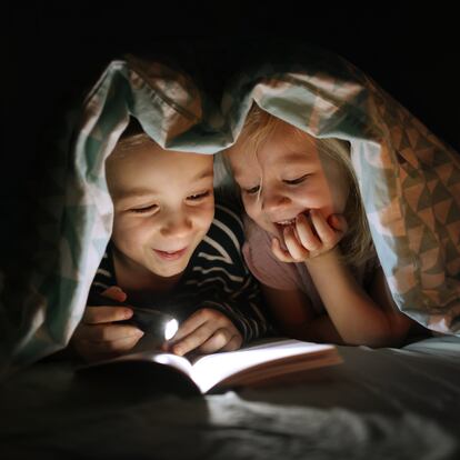 Children reading together in the bedroom, before to sleep