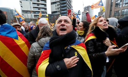 Un manifestante canta el himno catalán con la mano en el corazón.