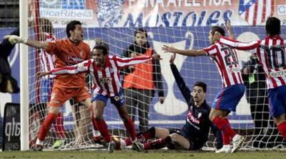 Assunçao, al que acuden a abrazar Simão y Agüero, celebra su gol, el segundo del Atlético.