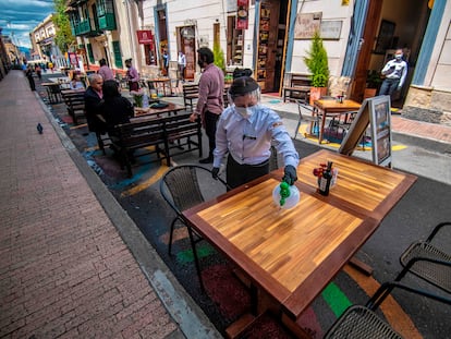 Una mujer limpia una mesa en un restaurante de Bogotá, el pasado 16 de octubre.