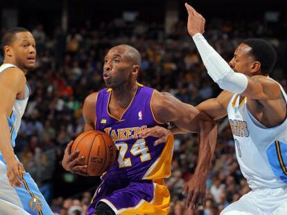 Kobe Bryant, entre dos jugadores de Denver.