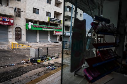 A street in Huwara blocked by the Israeli army, seen from the store run by Karim Ahmed.