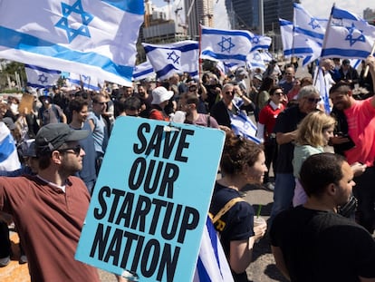 A demonstrator holds a placard reading "Save Our Startup Nation" during a protest, by tech workers against proposed judicial reforms, in Tel Aviv, Israel, on Thursday, March 9, 2023. Tens of thousands headed for protests across Israel over the government’s plan to cut the power of the Supreme Court, while the US defense secretary will shorten his visit and the chief of the army expressed alarm over a threat from reservists to withhold service. Photographer: Kobi Wolf/Bloomberg