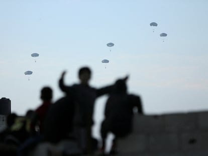 People run towards the aid packages dropped by the U.S. army on Gaza in early March.