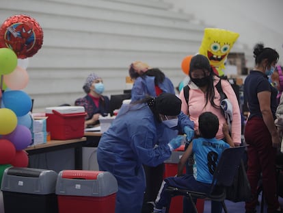 Una trabajadora de la salud administra una vacuna de Sinovac a un niño en Cuenca, Ecuador, el 23 de noviembre.