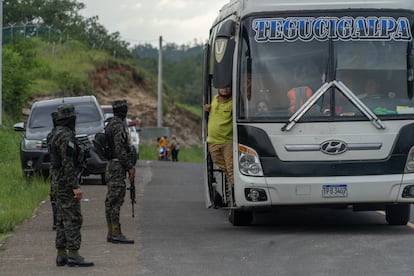 Members of the Honduran Army stop a passenger bus en route to Tegucigalpa.